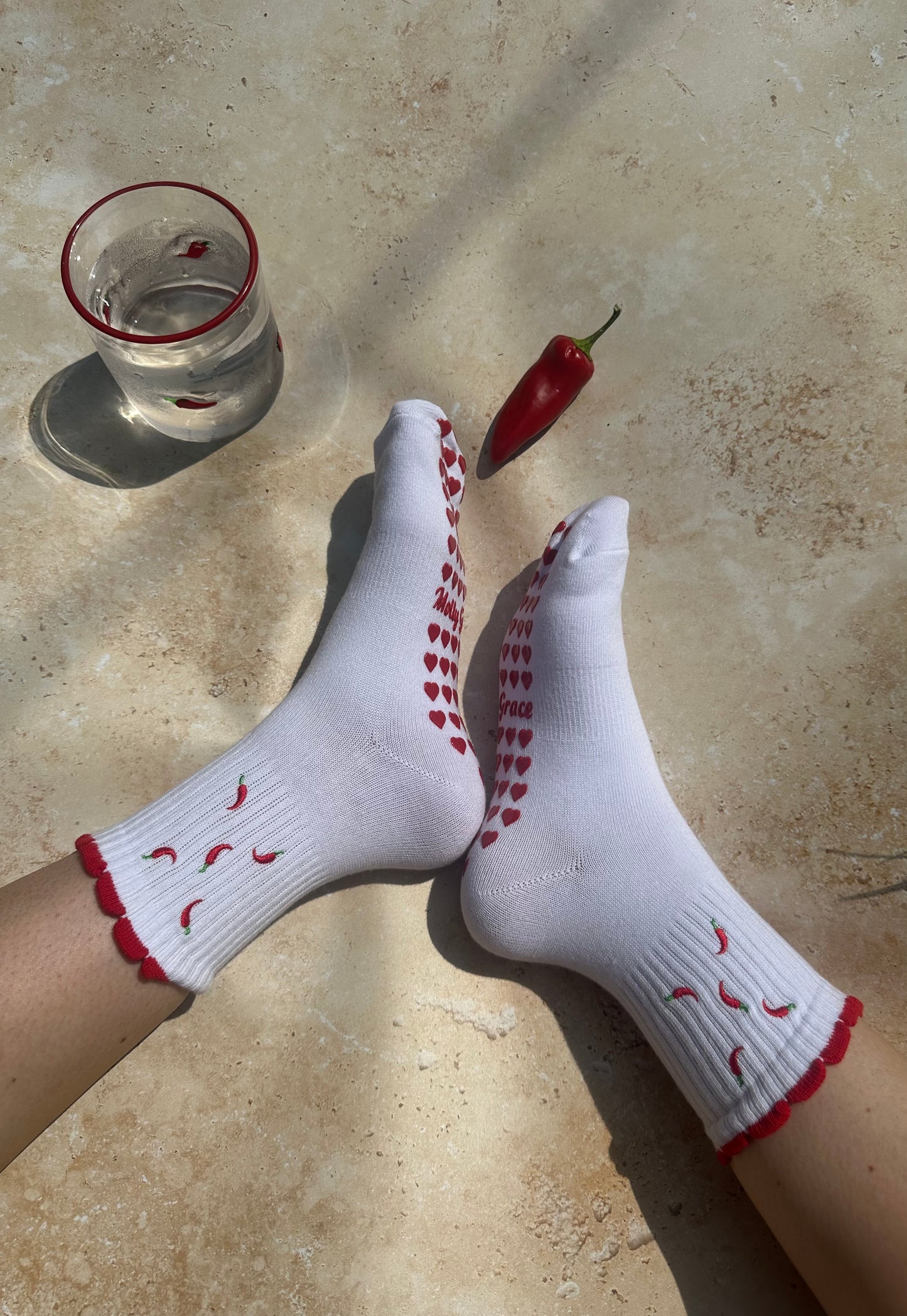 Red and white hot chili pepper grip sock with red heart grips