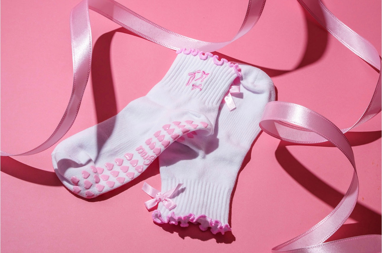 Pink bow coquette grip sock with pink heart grips