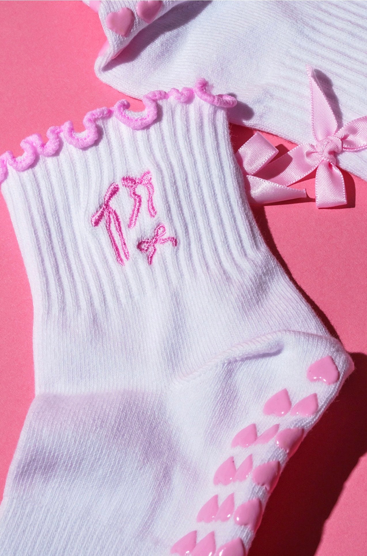 Pink bow coquette grip sock with pink heart grips