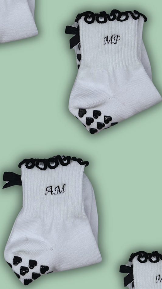 Black & white custom embroidered initial grip socks with black bow